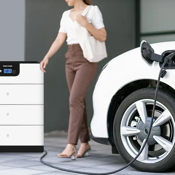 Focus image of electric vehicle recharging battery at home charging station with blurred woman walking in the background. Progressive concept of green energy technology applied in daily lifestyle.