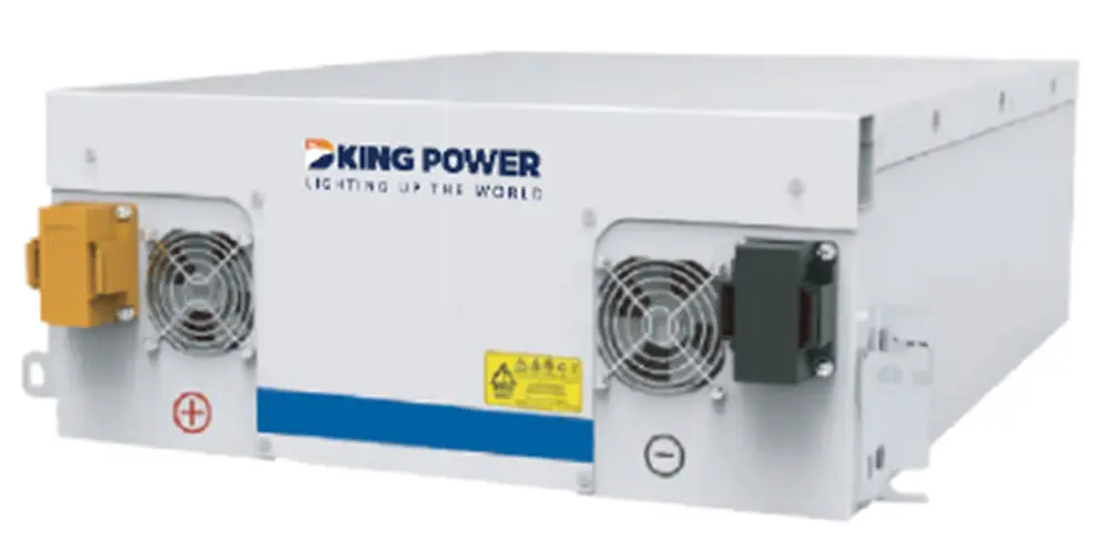 Focus image of electric vehicle recharging battery at home charging station with blurred woman walking in the background. Progressive concept of green energy technology applied in daily lifestyle.